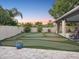 Beautiful backyard featuring a custom putting green, covered patio, and privacy fence at 121 Lindsay Ln # 31, Oldsmar, FL 34677