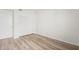 Bright bedroom featuring wood-look flooring and a closet with bi-fold doors at 121 Lindsay Ln # 31, Oldsmar, FL 34677
