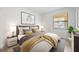 Well decorated bedroom with a soft bed, artwork, and natural light at 121 Lindsay Ln # 31, Oldsmar, FL 34677