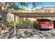 Assigned parking spot, carport 121 with red SUV parked in space at 121 Lindsay Ln # 31, Oldsmar, FL 34677
