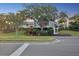 Clubhouse exterior with landscaping and signage, set against a backdrop of trees and a twilight sky at 121 Lindsay Ln # 31, Oldsmar, FL 34677