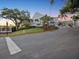 View of a community clubhouse and landscaping with a sign that says Ardea Country Club at 121 Lindsay Ln # 31, Oldsmar, FL 34677