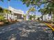 Clubhouse exterior view, long driveway with gray building and greenery at 121 Lindsay Ln # 31, Oldsmar, FL 34677