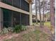 Low angle side view of the building's screened-in lanai and lush landscaping at 121 Lindsay Ln # 31, Oldsmar, FL 34677