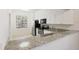 Bright kitchen features white cabinets, granite countertops, and stainless steel appliances at 121 Lindsay Ln # 31, Oldsmar, FL 34677