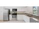 Bright kitchen features white cabinets, granite countertops, and stainless steel appliances at 121 Lindsay Ln # 31, Oldsmar, FL 34677