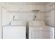 Bright laundry area with a white side-by-side washer and dryer at 121 Lindsay Ln # 31, Oldsmar, FL 34677