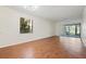 Spacious living room features hardwood floors and access to a screened patio at 121 Lindsay Ln # 31, Oldsmar, FL 34677