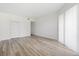 Open living area with plenty of natural light and laminate wood flooring at 121 Lindsay Ln # 31, Oldsmar, FL 34677