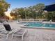 Inviting community pool with lounge chairs, umbrellas, and a lifeguard stand at 121 Lindsay Ln # 31, Oldsmar, FL 34677