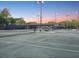 Outdoor tennis court featuring lighting, viewing pavilion with seating area, and well maintained surfaces at 121 Lindsay Ln # 31, Oldsmar, FL 34677