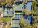 Aerial view of multiple tennis and pickleball courts in a well-maintained community with mature trees at 121 Lindsay Ln # 31, Oldsmar, FL 34677