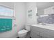 Bathroom with gray vanity, toilet, and decorative wall accents at 1244 31St E Ave, Bradenton, FL 34208