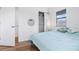 Bedroom with light teal bedding and wood flooring at 1244 31St E Ave, Bradenton, FL 34208