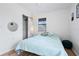 Bedroom with light teal bedding and wood flooring at 1244 31St E Ave, Bradenton, FL 34208