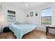 Bedroom with light teal bedding and wood flooring at 1244 31St E Ave, Bradenton, FL 34208