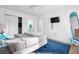 Bedroom with a bed, full-length mirror, and wall-mounted TV at 1244 31St E Ave, Bradenton, FL 34208