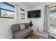 Cozy sitting area with grey couch and dining chair at 1244 31St E Ave, Bradenton, FL 34208