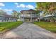 Elevated home with a spacious driveway and a balcony at 1244 31St E Ave, Bradenton, FL 34208