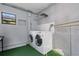 Laundry room with a washer and dryer, and green flooring at 1244 31St E Ave, Bradenton, FL 34208