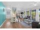 Open living space with teal accent wall, hardwood floors, and patio access at 1244 31St E Ave, Bradenton, FL 34208