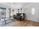 Living room with hardwood floors, comfy couch, and access to balcony at 1244 31St E Ave, Bradenton, FL 34208