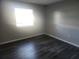 Spacious bedroom with large window and vinyl plank flooring at 12804 Waterbury Ave, Hudson, FL 34669