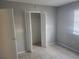 Simple bedroom with closet and tile floor at 12804 Waterbury Ave, Hudson, FL 34669