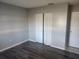Bedroom with closet and wood-look floors at 12804 Waterbury Ave, Hudson, FL 34669