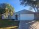 Charming one-story home with a well-maintained lawn and updated facade at 12804 Waterbury Ave, Hudson, FL 34669