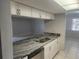 White cabinets, granite countertops, and a double sink at 12804 Waterbury Ave, Hudson, FL 34669