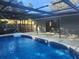 Inviting screened-in swimming pool with patio area at 12804 Waterbury Ave, Hudson, FL 34669