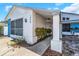 Side view of a charming white house with blue accents and walkway at 1339 Persimmon Dr, Holiday, FL 34691