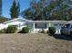 Ranch-style home with carport and mature landscaping at 4392 Craftsbury Dr, New Port Richey, FL 34652