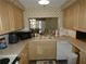 Kitchen features light wood cabinets and a dishwasher at 4392 Craftsbury Dr, New Port Richey, FL 34652