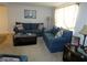 Living room featuring two blue sofas at 4392 Craftsbury Dr, New Port Richey, FL 34652