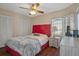 Bedroom with red upholstered bed and wood flooring at 4808 Vesper Ct, New Port Richey, FL 34655
