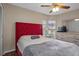 Bedroom with red headboard and ceiling fan at 4808 Vesper Ct, New Port Richey, FL 34655