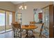 Dining area with a round table and four chairs, kitchen view at 4808 Vesper Ct, New Port Richey, FL 34655