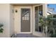 Front entry with a brown door, security screen, and sidelights at 4808 Vesper Ct, New Port Richey, FL 34655