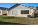 Rear view of house with vinyl siding, windows, and AC unit at 4808 Vesper Ct, New Port Richey, FL 34655