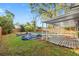 Backyard with a partially covered pool, wooden deck, and grassy area at 4939 18Th St, Zephyrhills, FL 33542