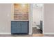 View of a bathroom through a doorway with gray vanity and toilet at 4939 18Th St, Zephyrhills, FL 33542
