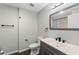 Bathroom with a dark vanity, white sink, and black fixtures at 4939 18Th St, Zephyrhills, FL 33542