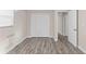 Bedroom with wood-look flooring, closet, and open doorway to another room at 4939 18Th St, Zephyrhills, FL 33542