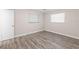 Empty bedroom with light gray walls and wood-look flooring at 4939 18Th St, Zephyrhills, FL 33542