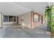 Covered carport area with a concrete floor, brick walls, and vine accents at 4939 18Th St, Zephyrhills, FL 33542
