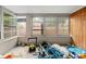 Enclosed patio with multiple windows and storage items present at 4939 18Th St, Zephyrhills, FL 33542