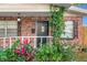 Close-up of the front door, with decorative ironwork, vines, and lush landscaping at 4939 18Th St, Zephyrhills, FL 33542