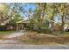 View of the front yard with mature trees, a driveway, and the front of the house at 4939 18Th St, Zephyrhills, FL 33542